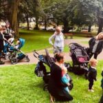 Group of volunteers, parents and children in park Home-Start Cambridgeshire