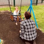 Home-Start Cambridgeshire volunteer with baby on swing