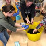 Home-Start Cambridgeshire volunteers with bucket of soil