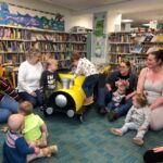 Home-Start Cambridgeshire volunteers with children in library